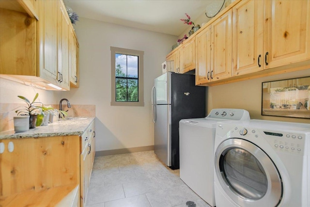 1150 Windmill Run, Wimberley, TX 78676 - laundry area featuring a sink, washer and clothes dryer, baseboards, and light tile patterned floors