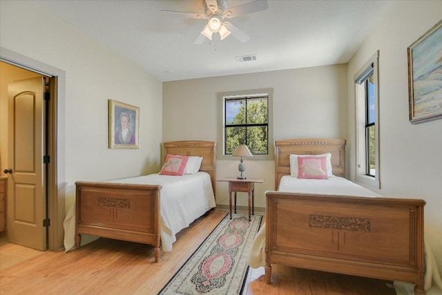 1150 Windmill Run, Wimberley, TX 78676 - bedroom featuring light wood-style floors and ceiling fan