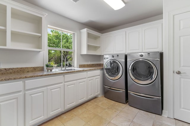 325 Onion Creek Ranch Rd, Driftwood, TX 78619 - laundry room with washer and clothes dryer, cabinet space, and light tile patterned flooring
