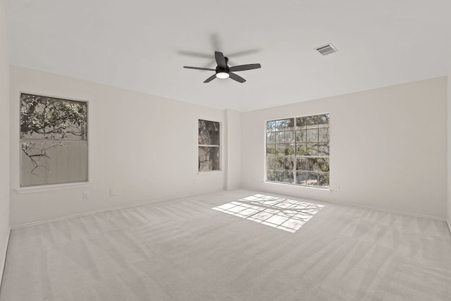 13223 Darwin Ln, Austin, TX 78729 - unfurnished room featuring carpet flooring, ceiling fan, plenty of natural light, and baseboards