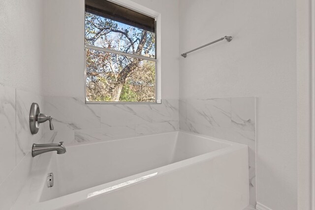 13223 Darwin Ln, Austin, TX 78729 - full bathroom featuring healthy amount of natural light and a tub to relax in