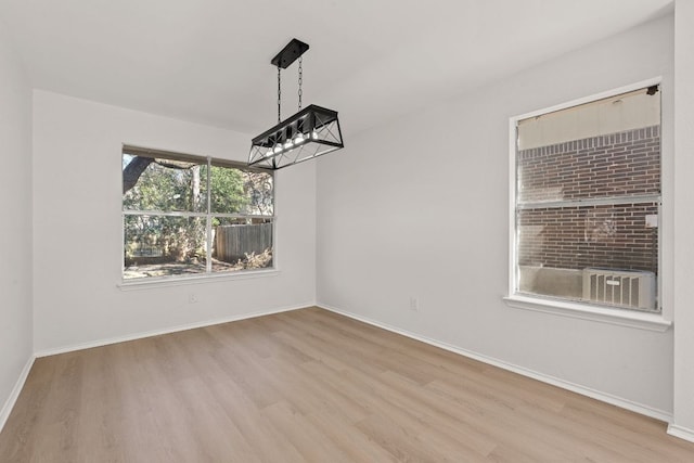 13223 Darwin Ln, Austin, TX 78729 - unfurnished dining area featuring wood finished floors and baseboards