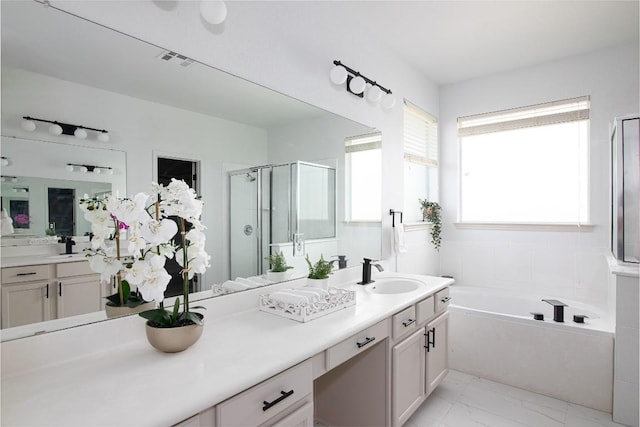 full bath with a shower stall, marble look tiles, a bath, and vanity