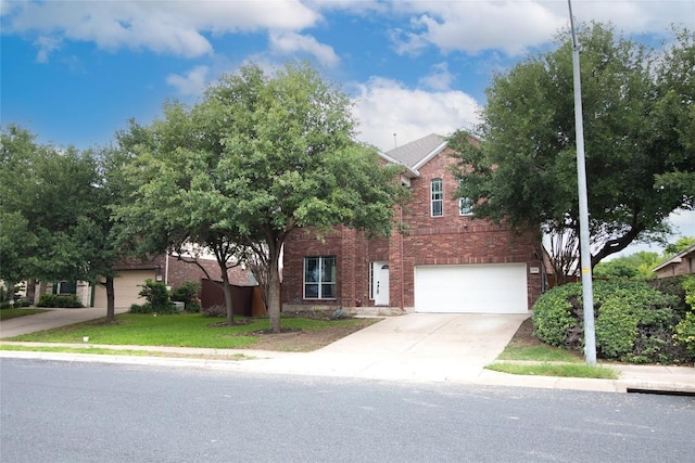 view of property hidden behind natural elements with brick siding, concrete driveway, and an attached garage