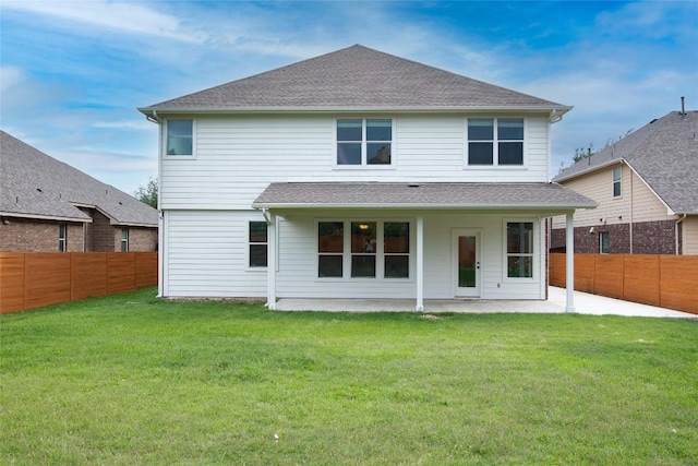 back of property with a patio and a shingled roof