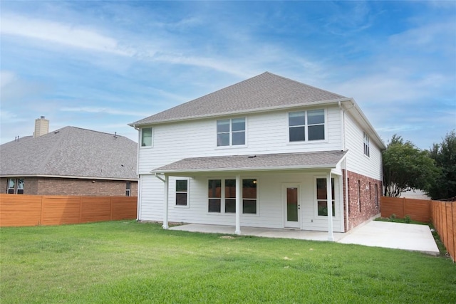 back of property with a patio and brick siding