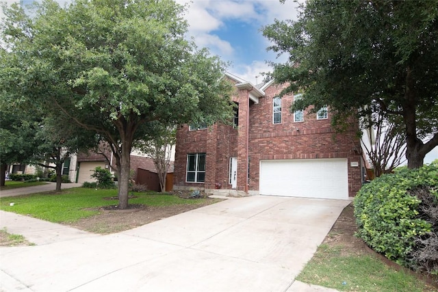 view of front of home featuring brick siding, a garage, and driveway