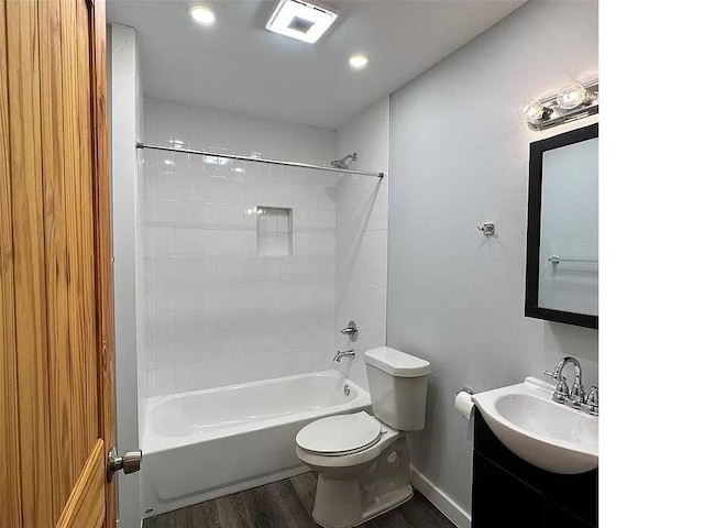 202 Prima St Unit A, Smithville, TX 78957 - full bathroom featuring wood finished floors, vanity, toilet, shower / bathtub combination, and baseboards