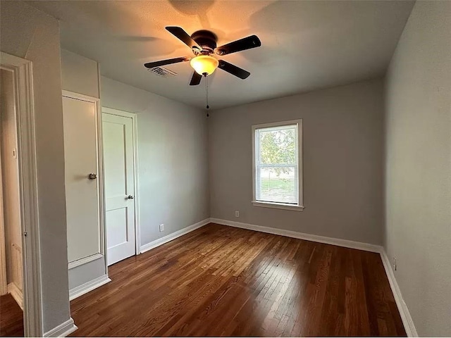 202 Prima St Unit A, Smithville, TX 78957 - unfurnished bedroom featuring dark wood-style flooring and a ceiling fan