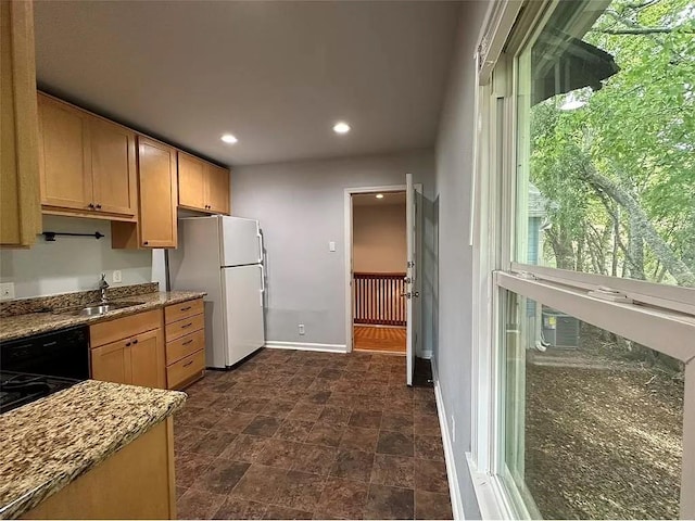 202 Prima St Unit A, Smithville, TX 78957 - kitchen featuring a sink, baseboards, freestanding refrigerator, recessed lighting, and stone countertops