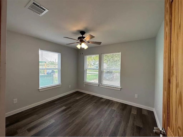 202 Prima St Unit A, Smithville, TX 78957 - spare room featuring dark wood finished floors, a ceiling fan, and baseboards