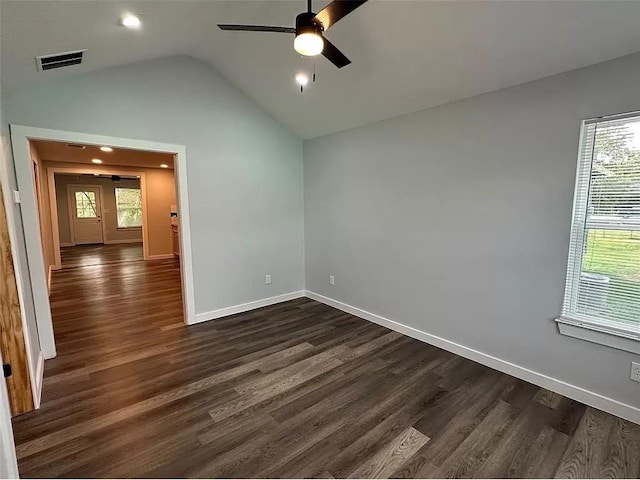 202 Prima St Unit A, Smithville, TX 78957 - empty room with a ceiling fan, dark wood finished floors, lofted ceiling, plenty of natural light, and baseboards