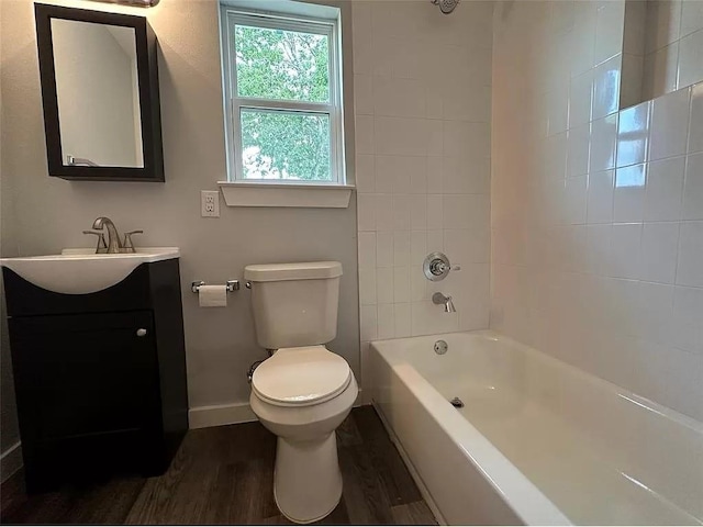 202 Prima St Unit A, Smithville, TX 78957 - bathroom with toilet, wood finished floors, vanity, baseboards, and  shower combination