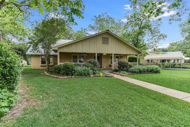 503 Colorado St, Smithville, TX 78957 - ranch-style house with stucco siding, a front lawn, and a detached carport