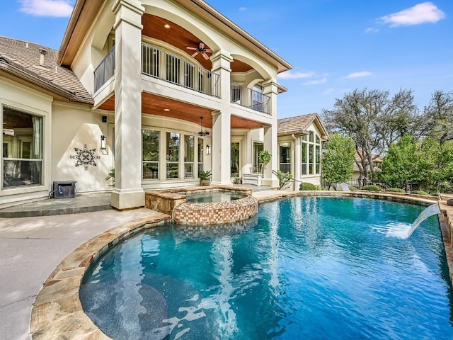 11701 Hunters Green Trl, Austin, TX 78732 - back of property featuring a balcony, ceiling fan, stucco siding, a patio, and a pool with connected hot tub