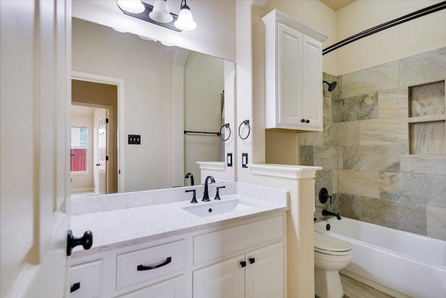 bathroom with toilet, shower / washtub combination, and vanity