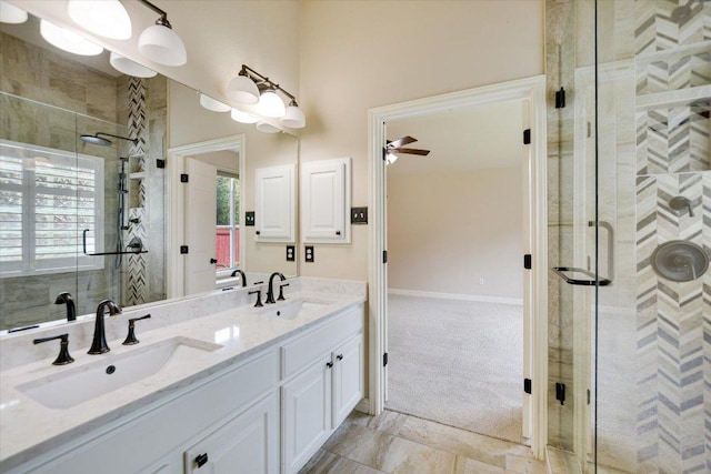 bathroom with a stall shower, double vanity, and ceiling fan