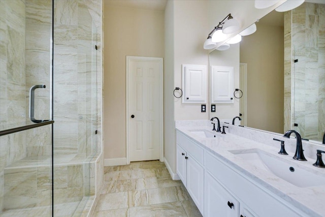 bathroom with a stall shower, double vanity, baseboards, and marble look tiles