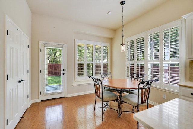 dining room with light wood-type flooring and baseboards