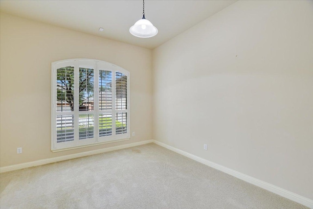 unfurnished room with carpet floors and baseboards