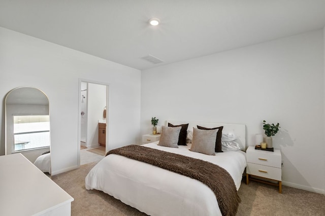 615 Backstays Loop, Kyle, TX 78640 - bedroom with light colored carpet, baseboards, and connected bathroom
