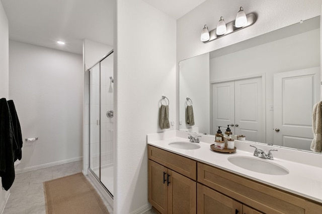 615 Backstays Loop, Kyle, TX 78640 - full bathroom with a shower stall, double vanity, tile patterned floors, and baseboards