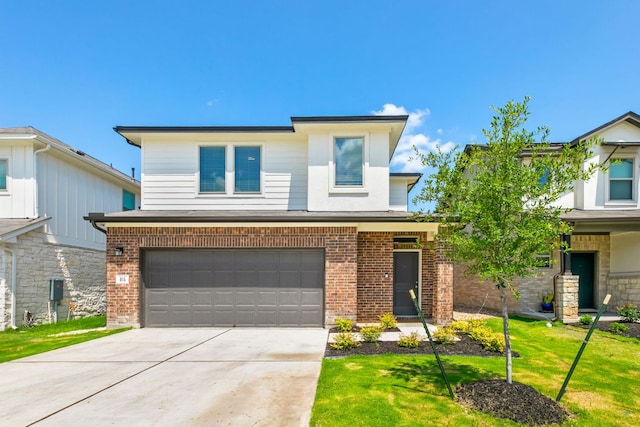 615 Backstays Loop, Kyle, TX 78640 - view of front of property with an attached garage, brick siding, concrete driveway, and a front lawn