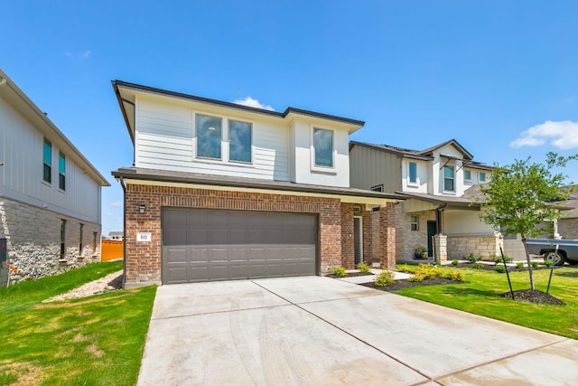 615 Backstays Loop, Kyle, TX 78640 - view of front of property with an attached garage, brick siding, concrete driveway, and a front yard