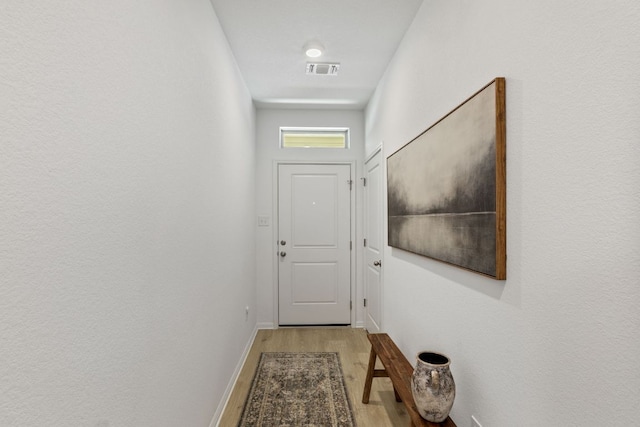 615 Backstays Loop, Kyle, TX 78640 - doorway to outside featuring light wood-type flooring and baseboards