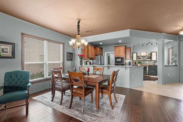 214 Fieldstone Dr, Georgetown, TX 78633 - dining room featuring a chandelier, light wood-style floors, baseboards, and rail lighting