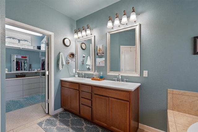 214 Fieldstone Dr, Georgetown, TX 78633 - full bath featuring a spacious closet, double vanity, tile patterned floors, and baseboards