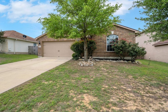 504 Sapphire Ln, Jarrell, TX 76537 - ranch-style home featuring brick siding, concrete driveway, an attached garage, and a front yard