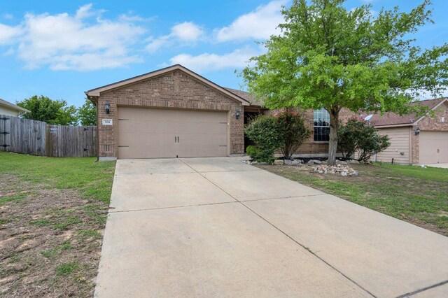 504 Sapphire Ln, Jarrell, TX 76537 - view of front of property featuring brick siding, driveway, and an attached garage