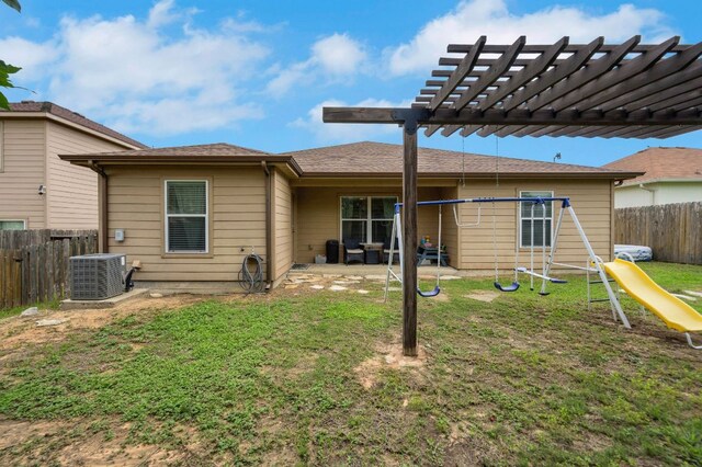 504 Sapphire Ln, Jarrell, TX 76537 - rear view of house with central air condition unit, a playground, a pergola, and a patio