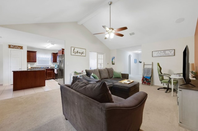 504 Sapphire Ln, Jarrell, TX 76537 - living area with light carpet, ceiling fan, arched walkways, beam ceiling, and high vaulted ceiling