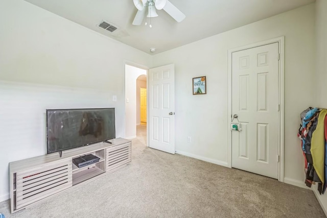 504 Sapphire Ln, Jarrell, TX 76537 - unfurnished living room with ceiling fan, arched walkways, carpet flooring, and baseboards