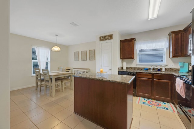 504 Sapphire Ln, Jarrell, TX 76537 - kitchen with black electric range oven, light tile patterned floors, a kitchen island, dark stone counters, and dishwasher