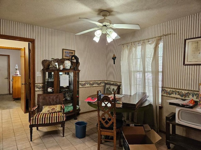 102 Stubblefield Dr, Elgin, TX 78621 - dining room featuring wallpapered walls, a textured ceiling, a ceiling fan, and light tile patterned floors