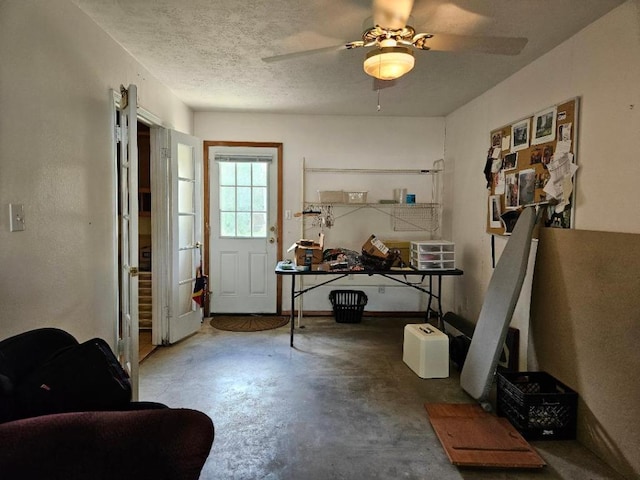 102 Stubblefield Dr, Elgin, TX 78621 - doorway to outside featuring concrete floors, a ceiling fan, and a textured ceiling