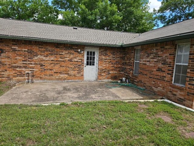 102 Stubblefield Dr, Elgin, TX 78621 - rear view of house featuring a patio area, a lawn, and brick siding