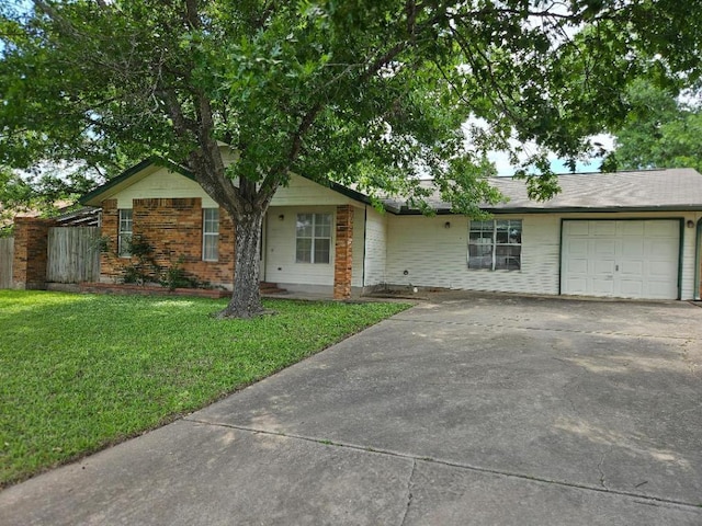 102 Stubblefield Dr, Elgin, TX 78621 - ranch-style home featuring a garage, a front lawn, and concrete driveway