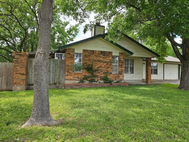 102 Stubblefield Dr, Elgin, TX 78621 - view of front of home featuring a garage and a chimney