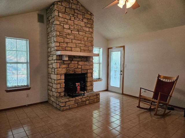 102 Stubblefield Dr, Elgin, TX 78621 - unfurnished living room featuring vaulted ceiling, plenty of natural light, a ceiling fan, baseboards, and a textured ceiling
