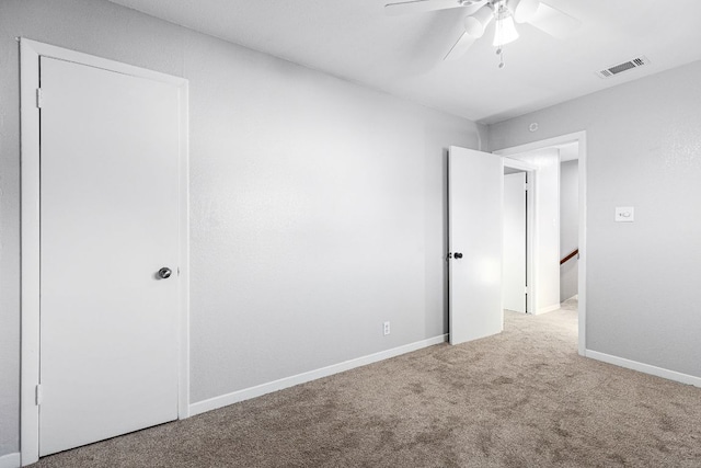 unfurnished bedroom with carpet, a ceiling fan, and baseboards