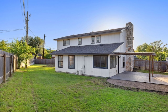 back of property with roof with shingles, a patio, a chimney, and ac unit