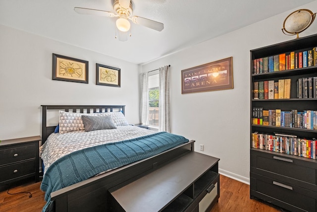 bedroom featuring wood finished floors, baseboards, and a ceiling fan