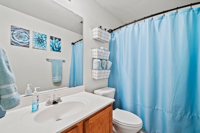 bathroom featuring toilet, vanity, and a shower with shower curtain