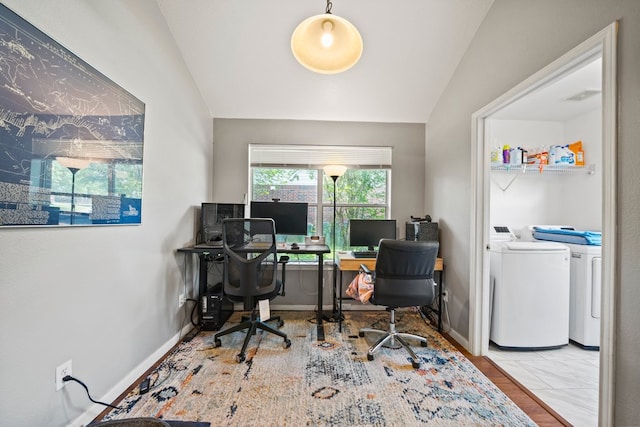 office space featuring washing machine and dryer, lofted ceiling, and baseboards