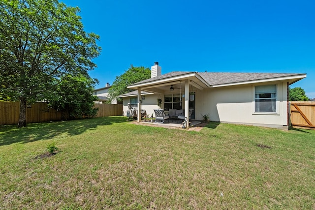 back of house featuring ceiling fan, a chimney, a patio, stucco siding, and an outdoor living space