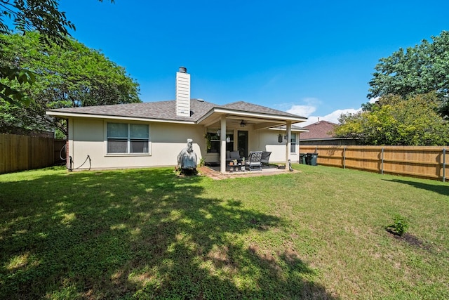back of house featuring ceiling fan, a patio, a chimney, and a shingled roof